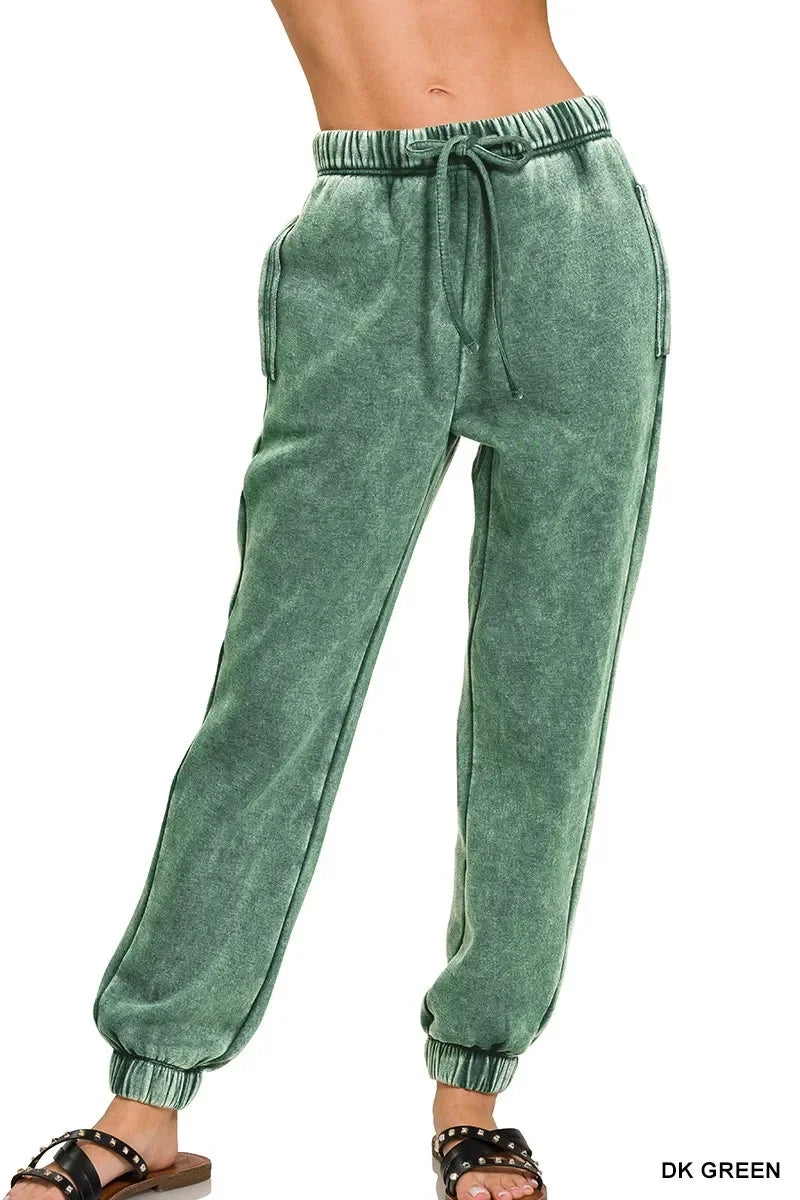 Dark green acid wash joggers with drawstring waist and side pockets, paired with black sandals
