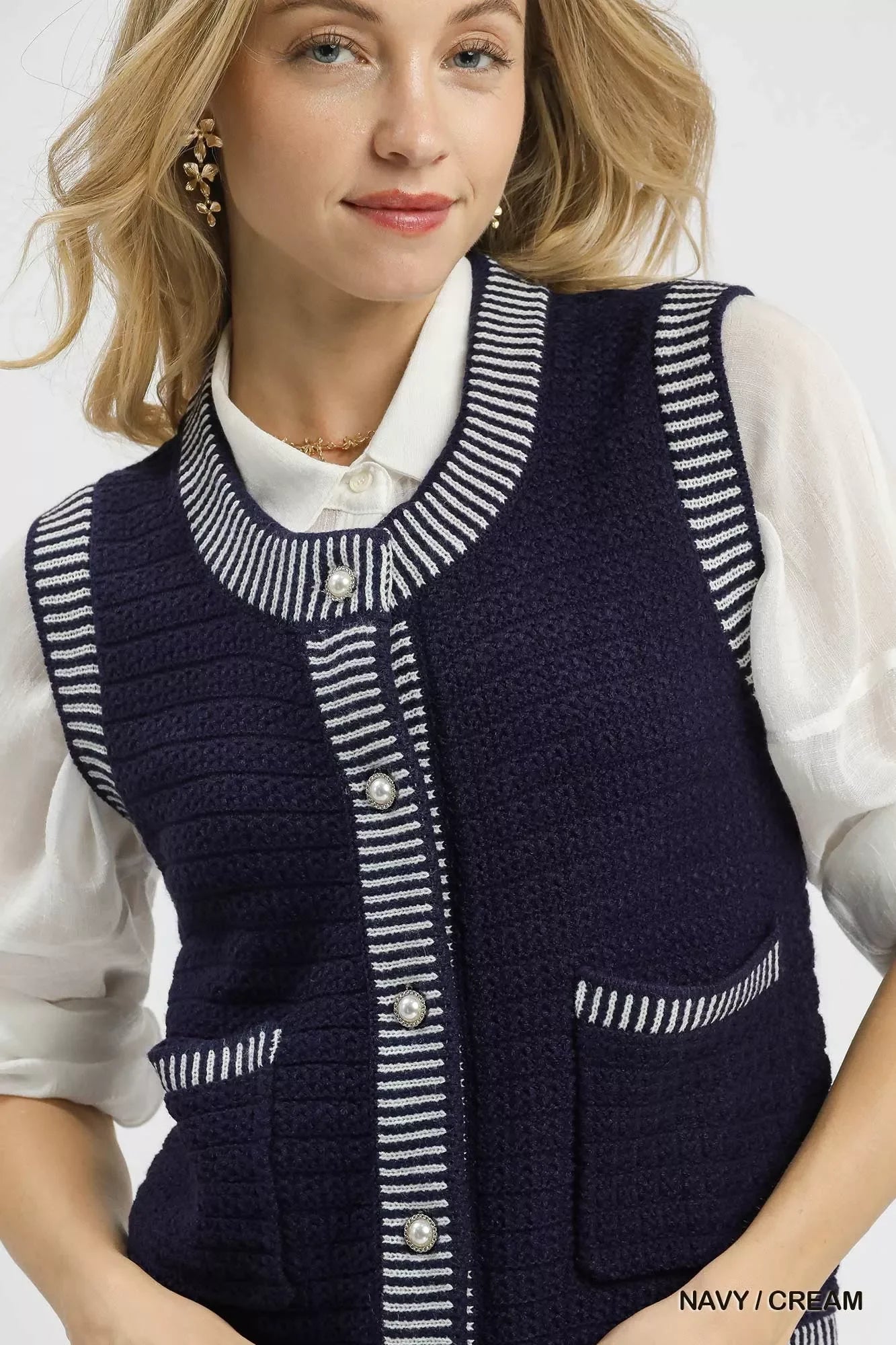 Navy and cream striped knit vest with pearl buttons, styled over white blouse for trendy, happy look