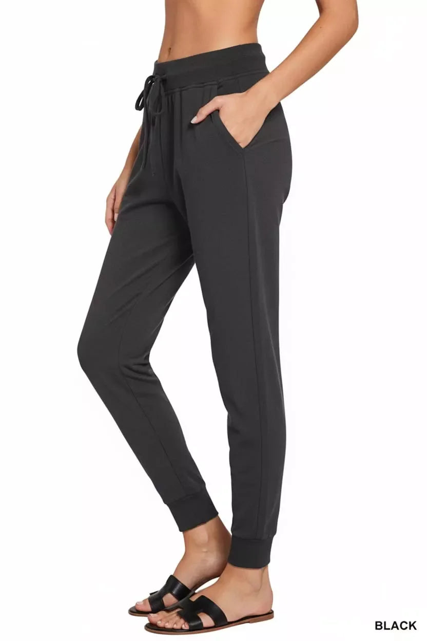 Black drawstring jogger pants with side pockets, comfy fit, paired with sandals