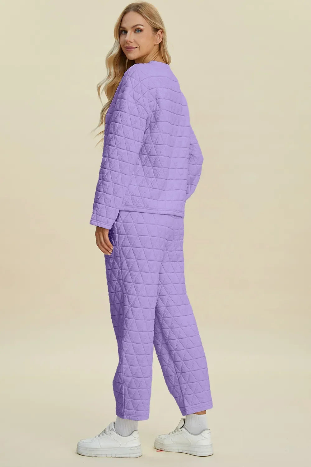 Lavender quilted pajama set with cozy long sleeves and relaxed fit, paired with white sneakers for comfy style.