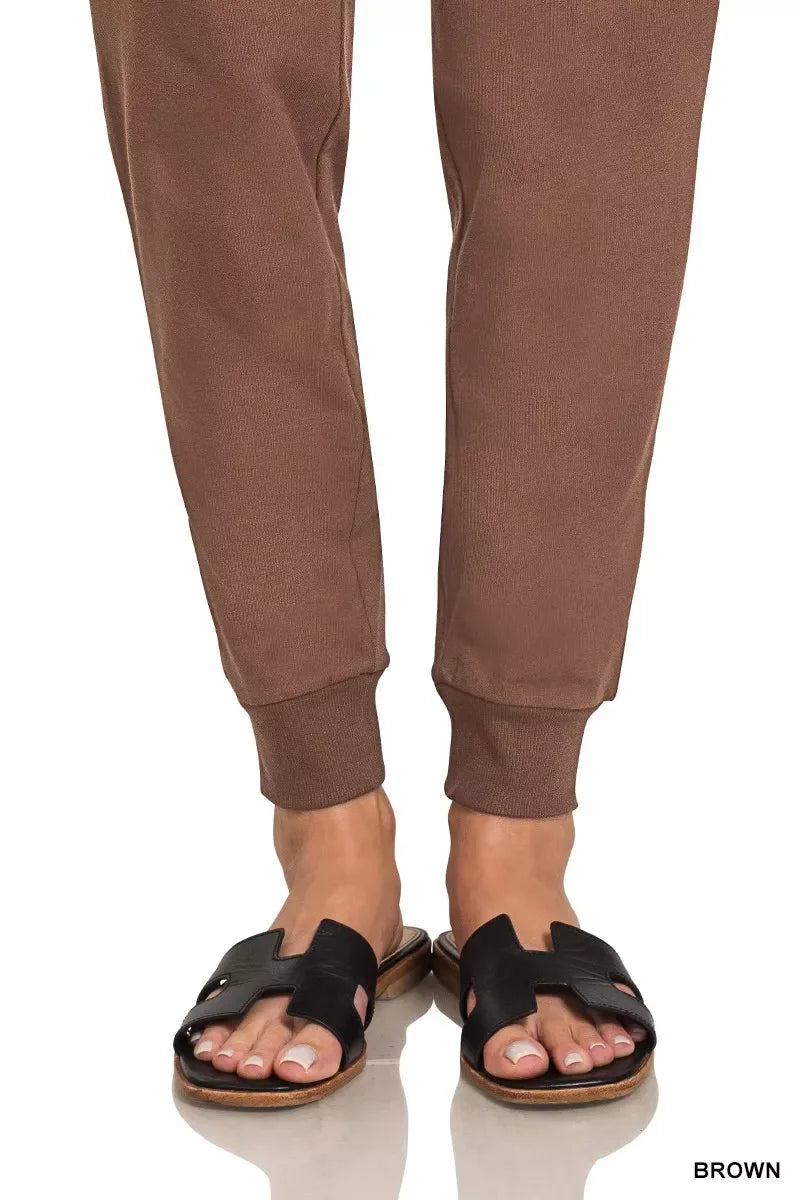 Brown ribbed jogger pants with black slide sandals, stylish and comfortable for everyday wear