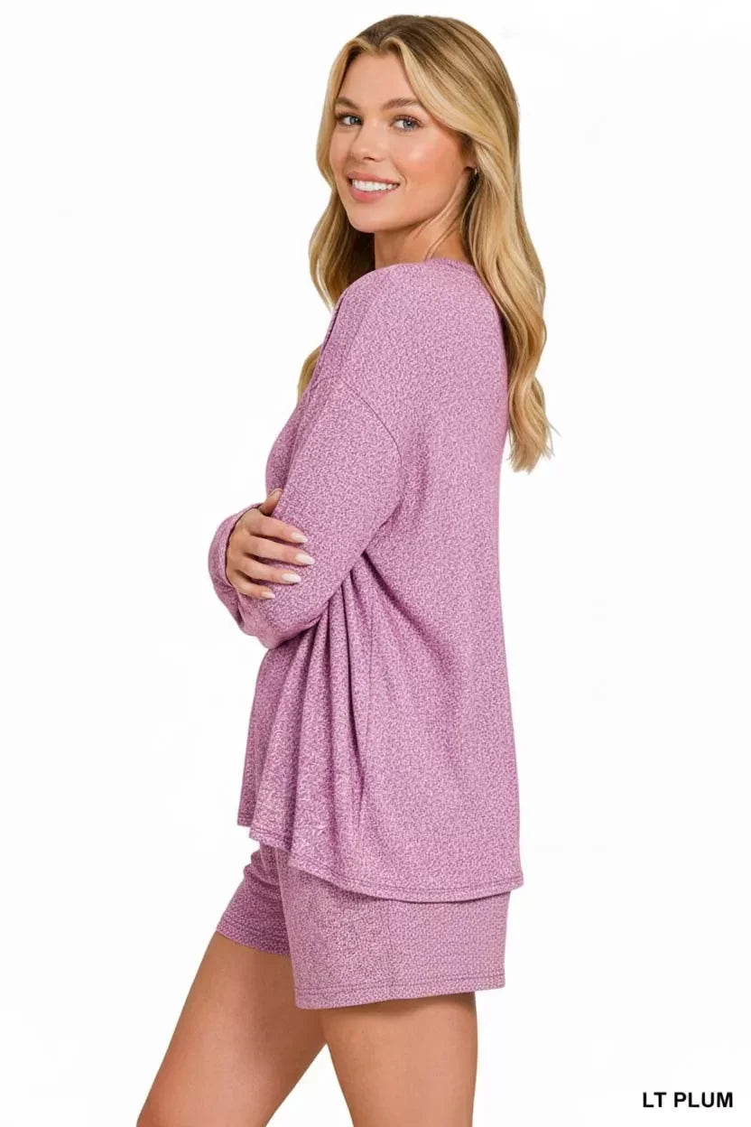 Woman in light plum cozy lounge set, soft textured long sleeve top and shorts, trendy comfortable outfit