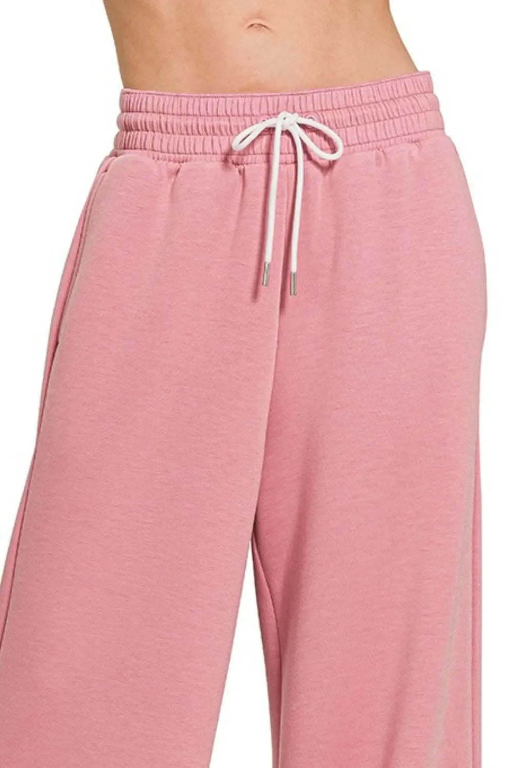 Pink wide-leg sweatpants with white drawstring waistband, comfy and trendy for everyday wear