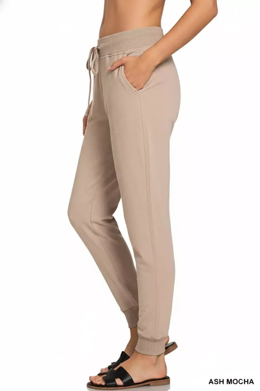 Ash Mocha jogger pants with drawstring waist, side pockets, and cuffed ankles, styled with sandals