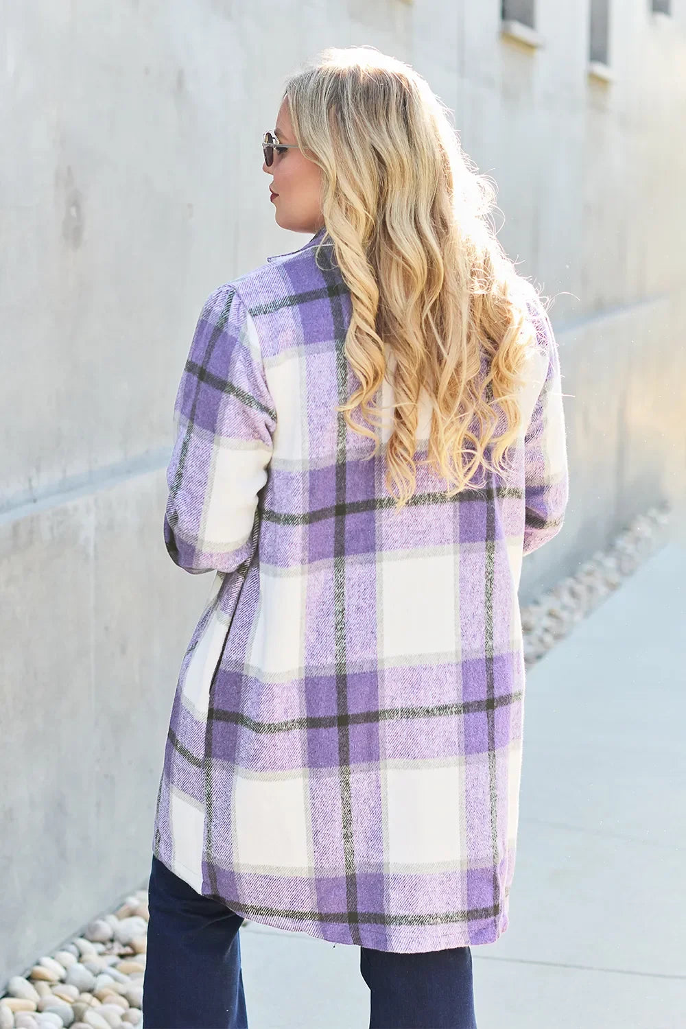 Woman in purple and white plaid flannel shirt, trendy fall outfit, happy stylish look