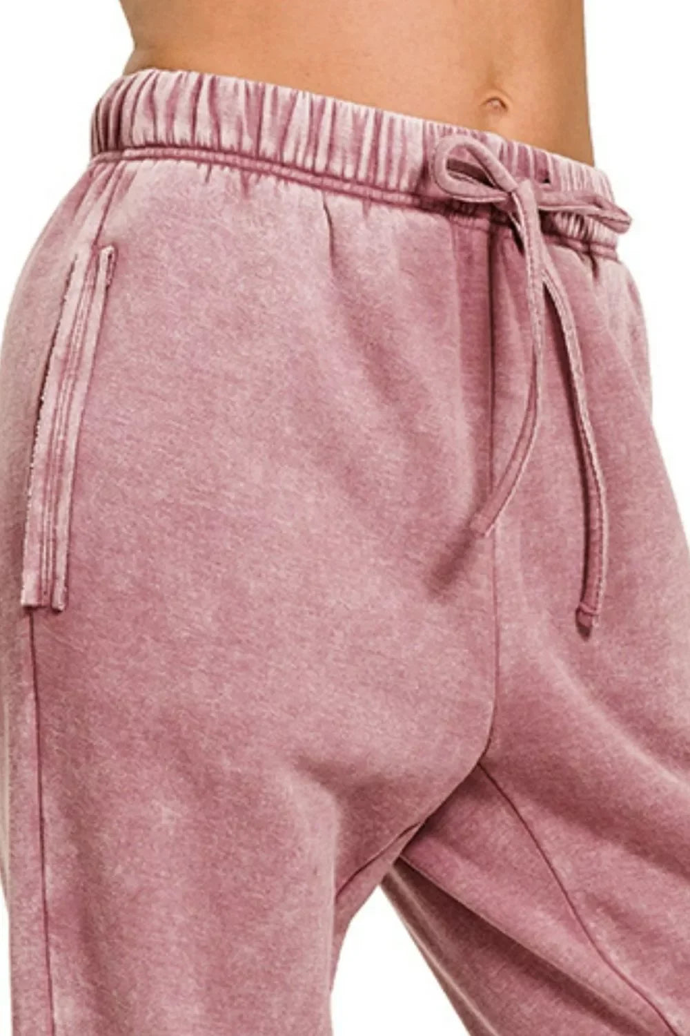 Soft pink velour joggers with drawstring waist and side pockets, cozy and trendy for everyday wear