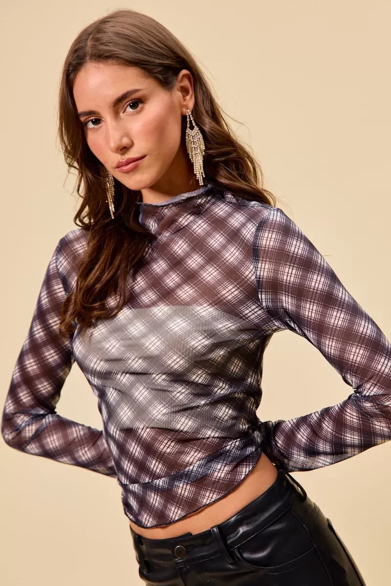 Sheer plaid long sleeve crop top with ruched front, paired with black leather pants and statement earrings