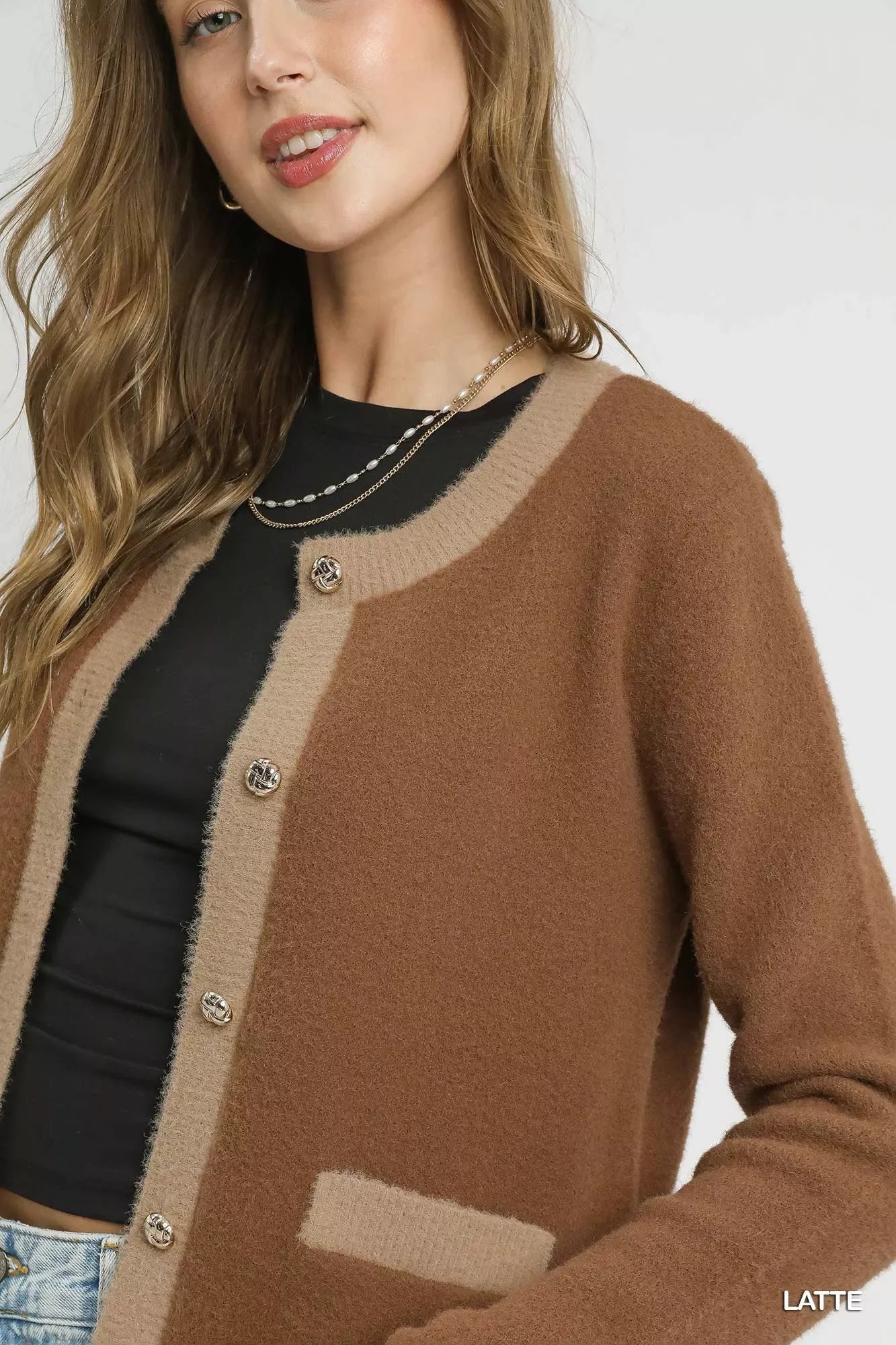 Cozy latte brown cardigan with contrast trim and gold buttons, styled with black top and layered necklace